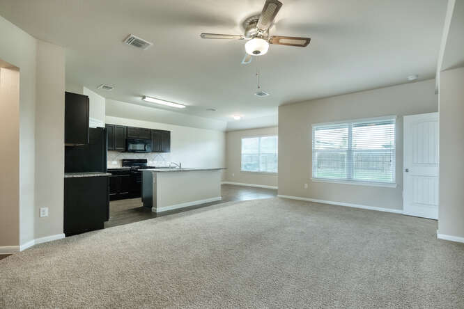 232 Voss Kyle, TX 78640 - Photo 2 of 15 Open-concept living area featuring light-colored carpeting and a ceiling fan with integrated lighting