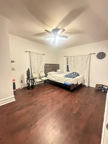 a spacious bedroom with a bed and a chandelier