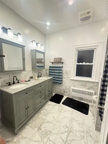 a spacious bathroom with a sink a mirror and a bathtub