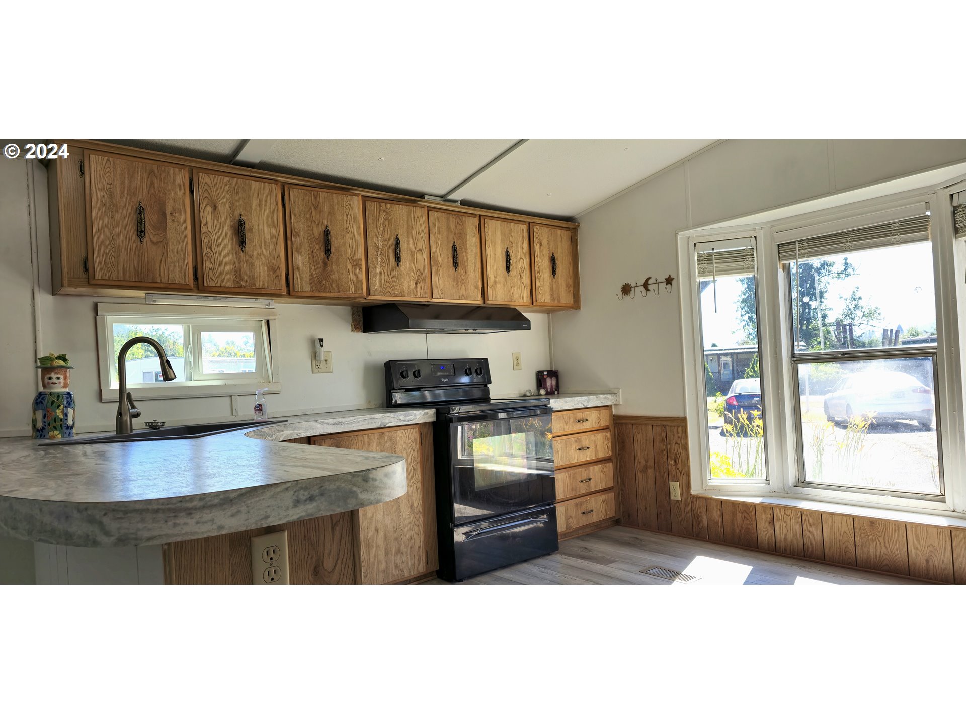 7080 Thurston Road, Unit 12 Springfield, OR 97478 - Photo 2 of 13 a kitchen with kitchen island granite countertop a sink cabinets stainless steel appliances and a counter top space
