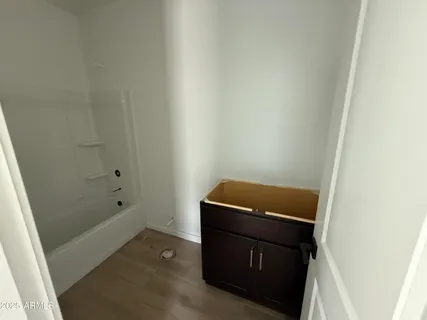 a living room with stainless steel appliances kitchen island granite countertop a refrigerator a stove a sink and a microwave oven on the blue kitchen countertops