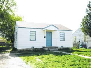 4413 South Travis Street Amarillo, TX 79110 - Photo 1 of 1 a front view of a house with a yard