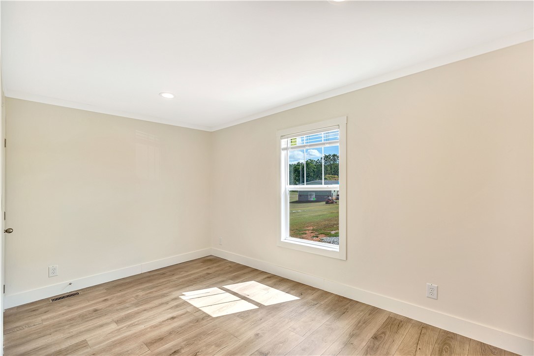 205 Wade Farm Road Fair Play, SC 29643 - Photo 21 of 23 Smooth wood floors and crisp white trim frame a bright window in this versatile space.