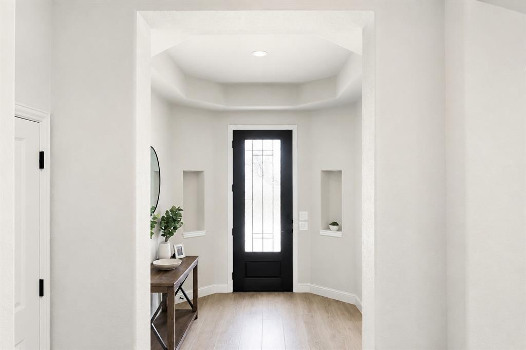 5225 Rowlan Row Midlothian, TX 76065 - Photo 2 of 9 Wood-finish flooring leading to a black front door with decorative glass