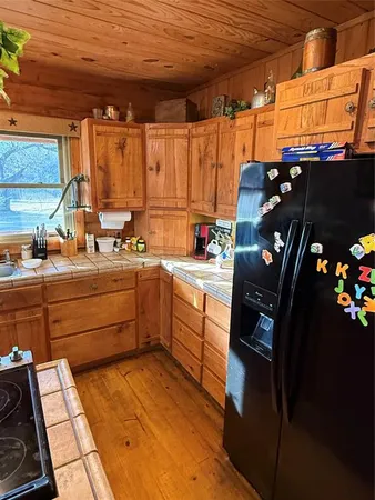a kitchen with a sink window and cabinets