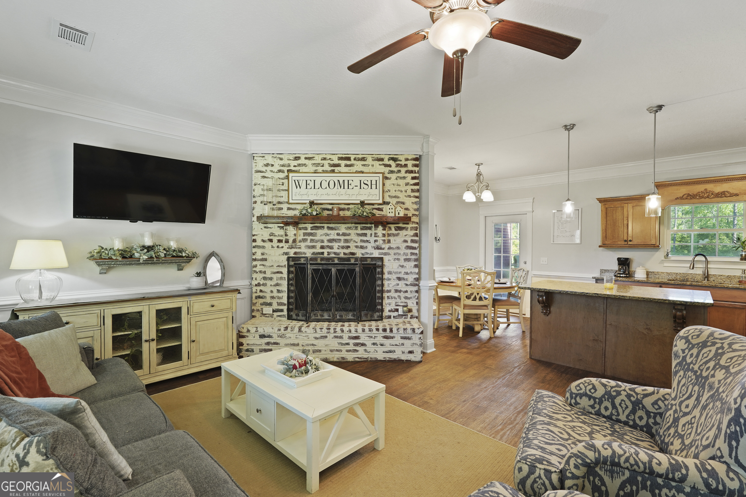 1653 Sutherland Road Townsend, GA 31331 - Photo 11 of 73 a living room with furniture a fireplace and a flat screen tv