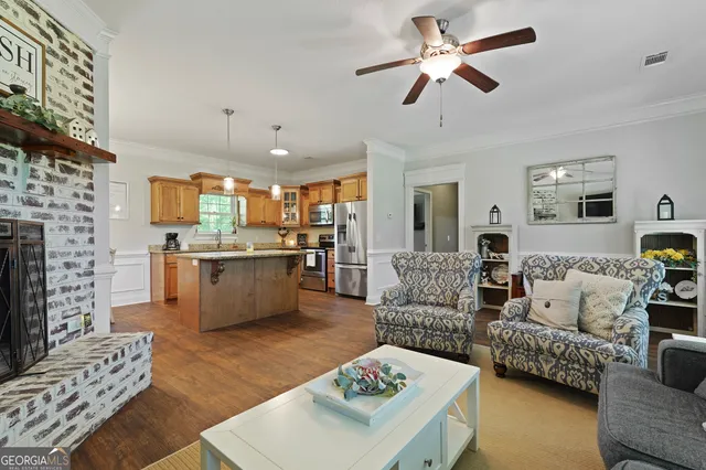 a kitchen with stainless steel appliances granite countertop a sink a stove and refrigerator