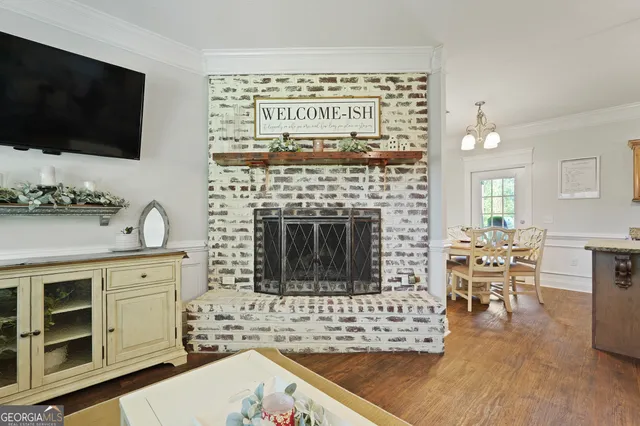 a kitchen with a sink a center island cabinets and wooden floor