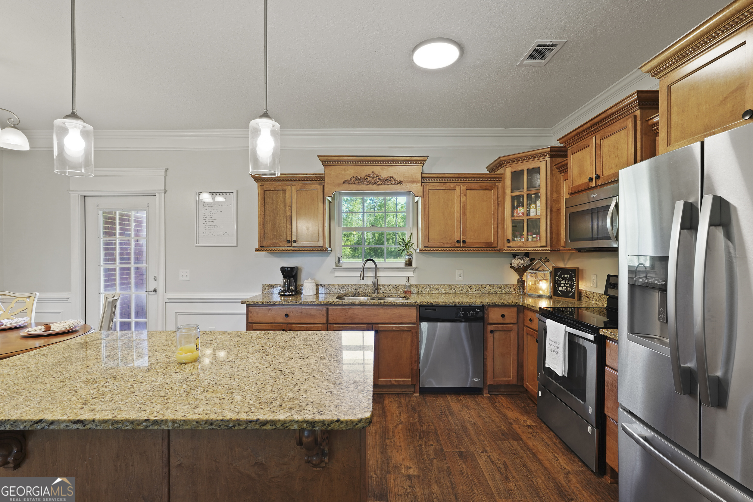 1653 Sutherland Road Townsend, GA 31331 - Photo 21 of 73 a kitchen with stainless steel appliances granite countertop a sink a stove and refrigerator
