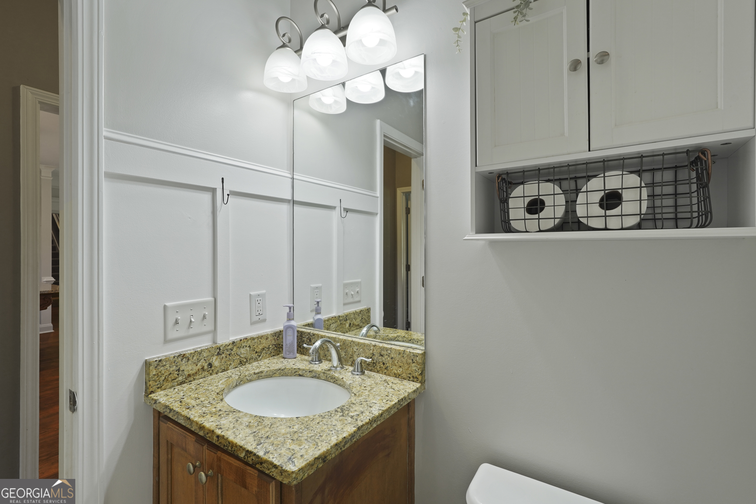 1653 Sutherland Road Townsend, GA 31331 - Photo 30 of 73 a bathroom with a granite countertop sink a mirror and vanity