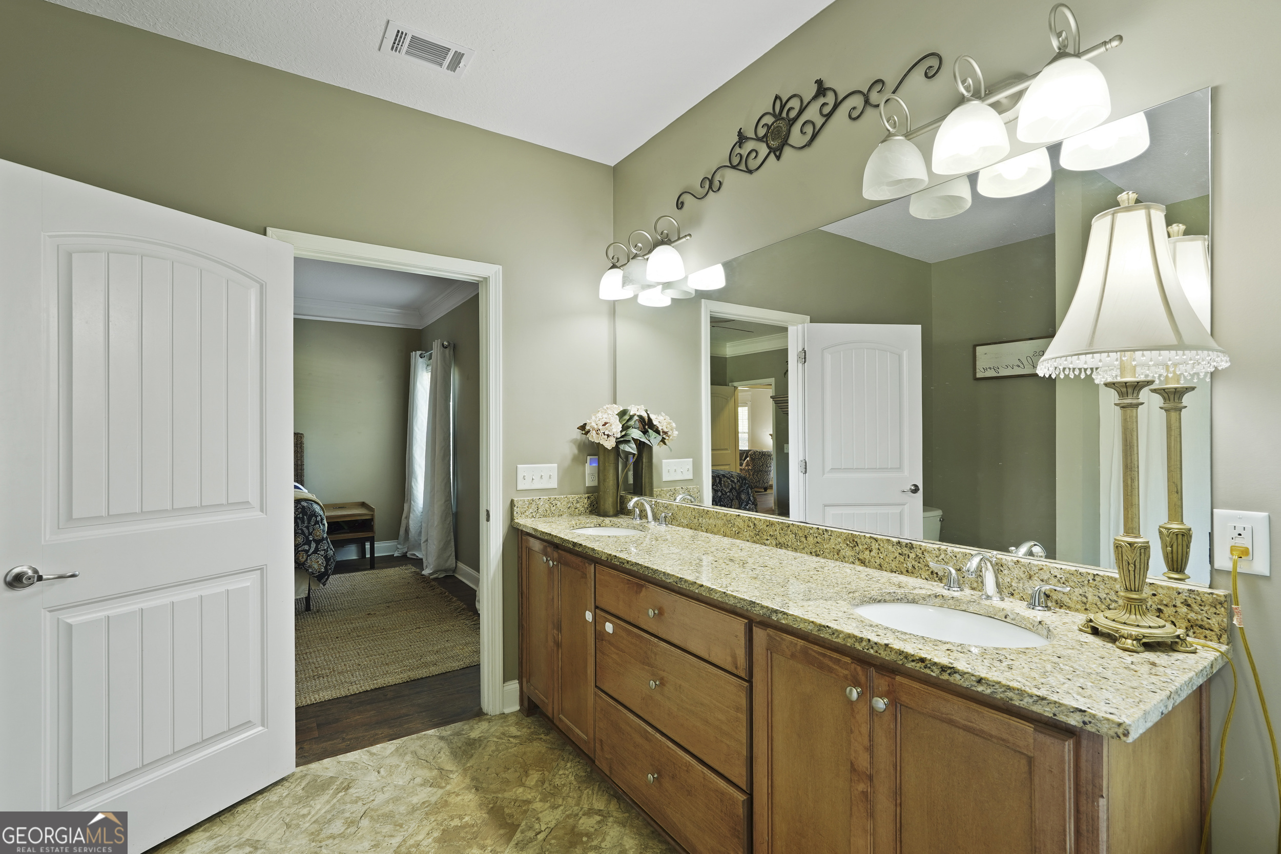 1653 Sutherland Road Townsend, GA 31331 - Photo 39 of 73 a en suite bathroom with a granite countertop sink and a mirror