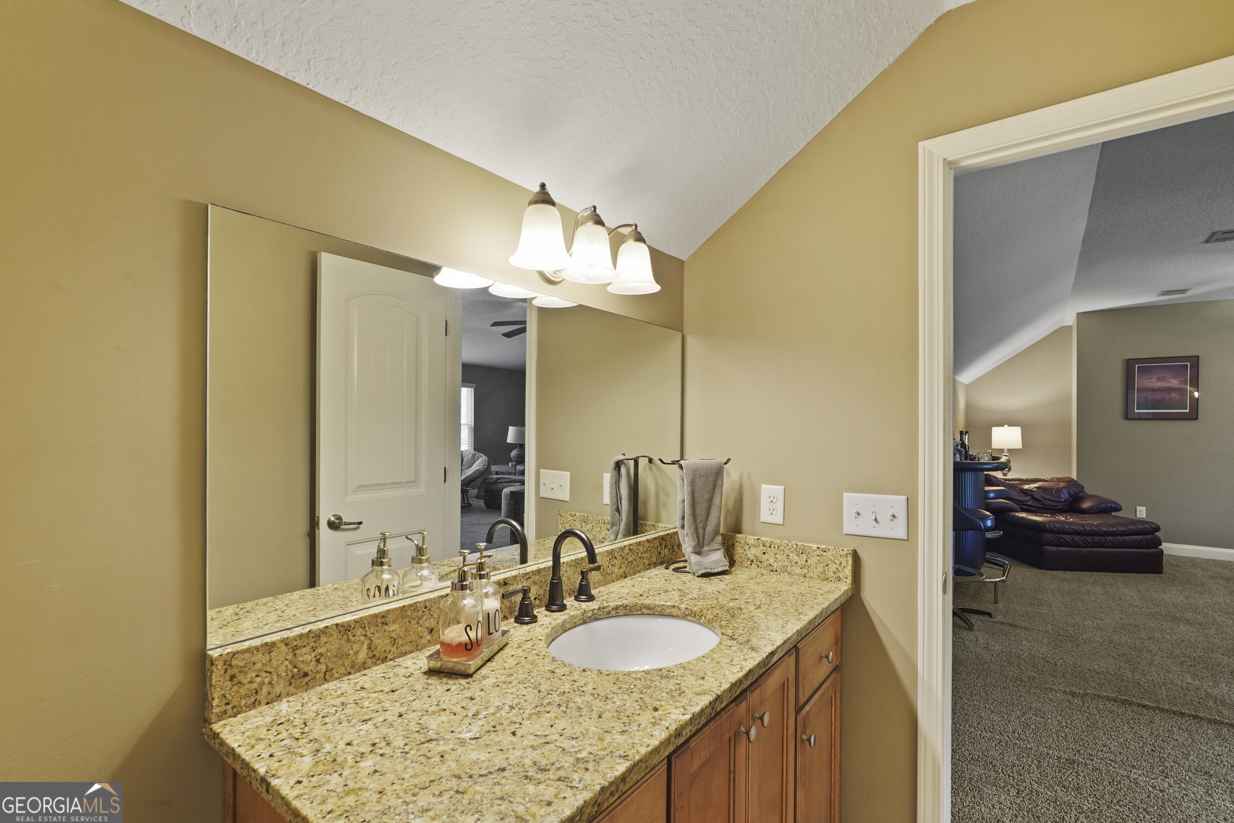 1653 Sutherland Road Townsend, GA 31331 - Photo 54 of 73 a bathroom with a granite countertop sink and a mirror