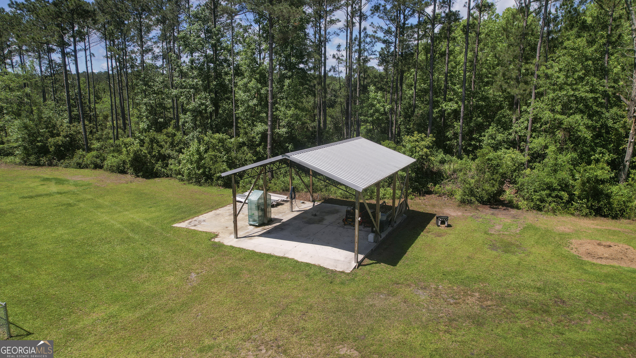 1653 Sutherland Road Townsend, GA 31331 - Photo 67 of 73 a view of a backyard with table and chairs with wooden fence