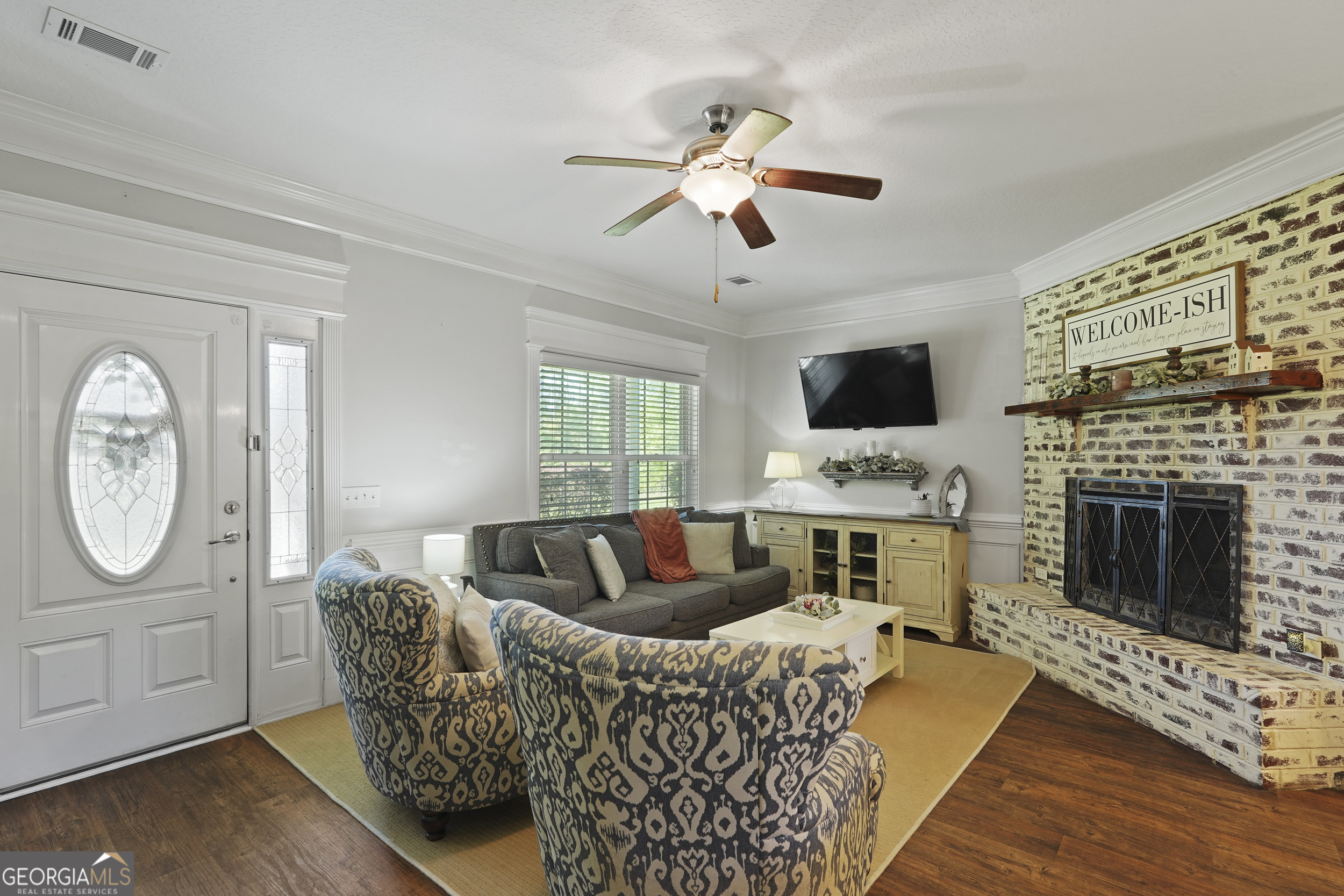 1653 Sutherland Road Townsend, GA 31331 - Photo 9 of 73 a living room with furniture a fireplace and a flat screen tv
