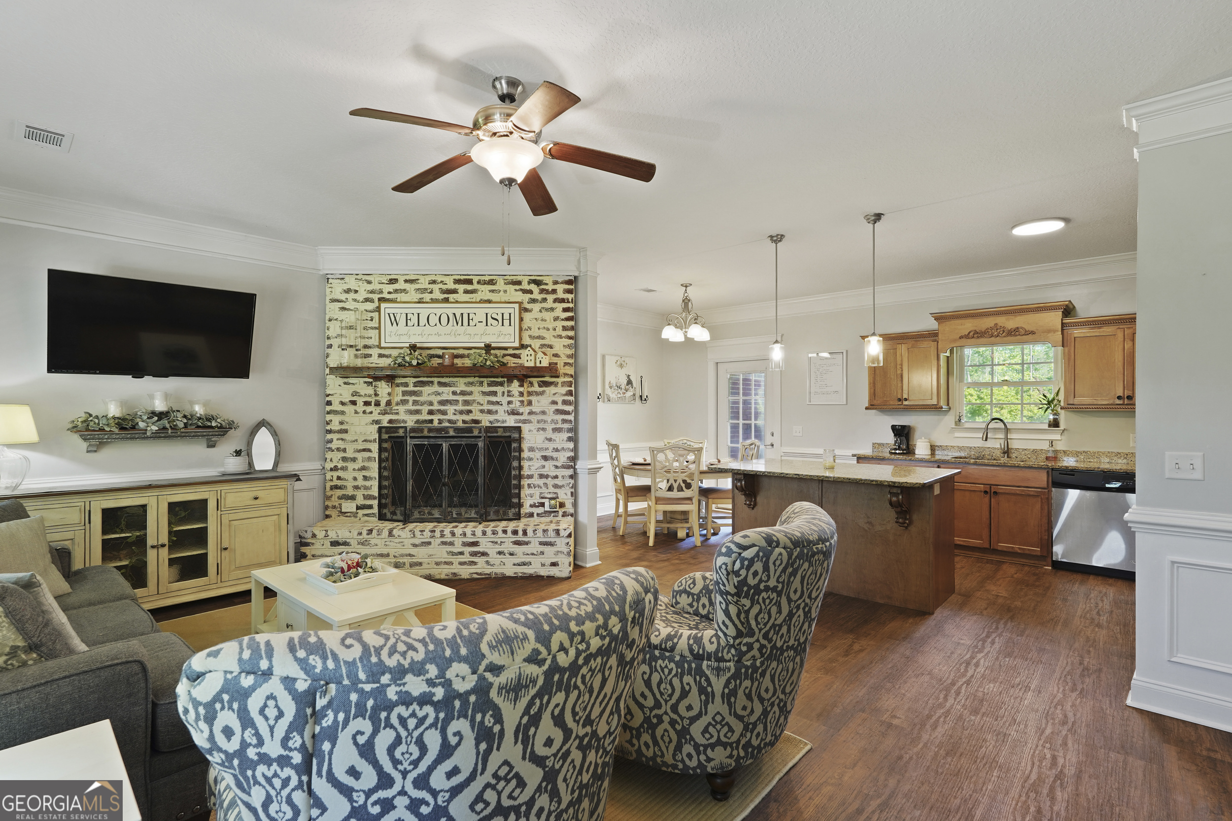 1653 Sutherland Road Townsend, GA 31331 - Photo 10 of 73 a living room with furniture a fireplace and a flat screen tv