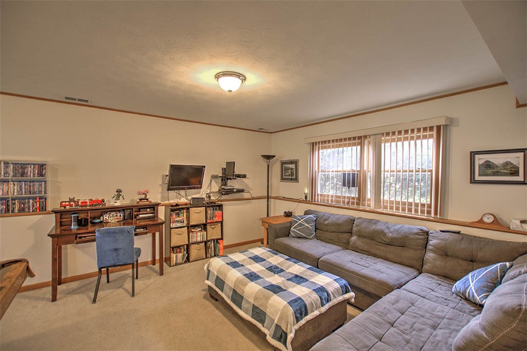 4081 Sheffield Court Decatur, IL 62526 - Photo 17 of 29 a living room with furniture and a flat screen tv