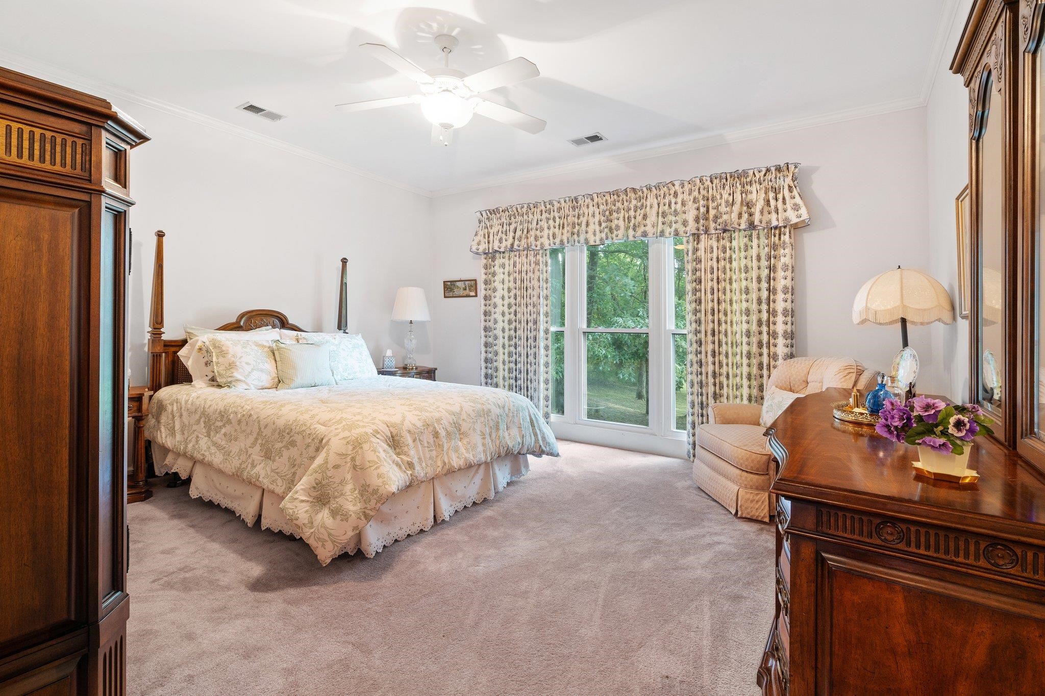6500 State Line Road Memphis, TN 38141 - Photo 17 of 40 Bedroom featuring light colored carpet, crown molding, and a ceiling fan