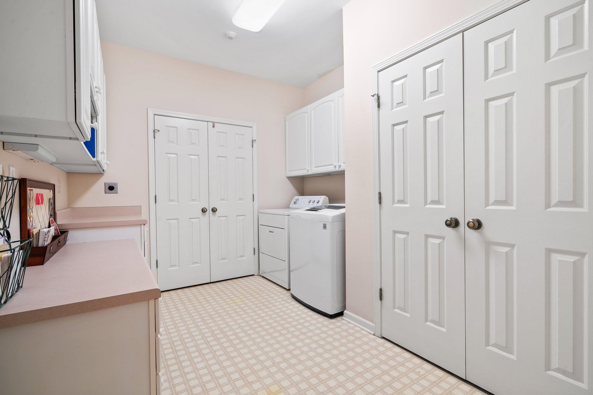 6500 State Line Road Memphis, TN 38141 - Photo 20 of 40 Washroom with light flooring, cabinet space, and washing machine and dryer