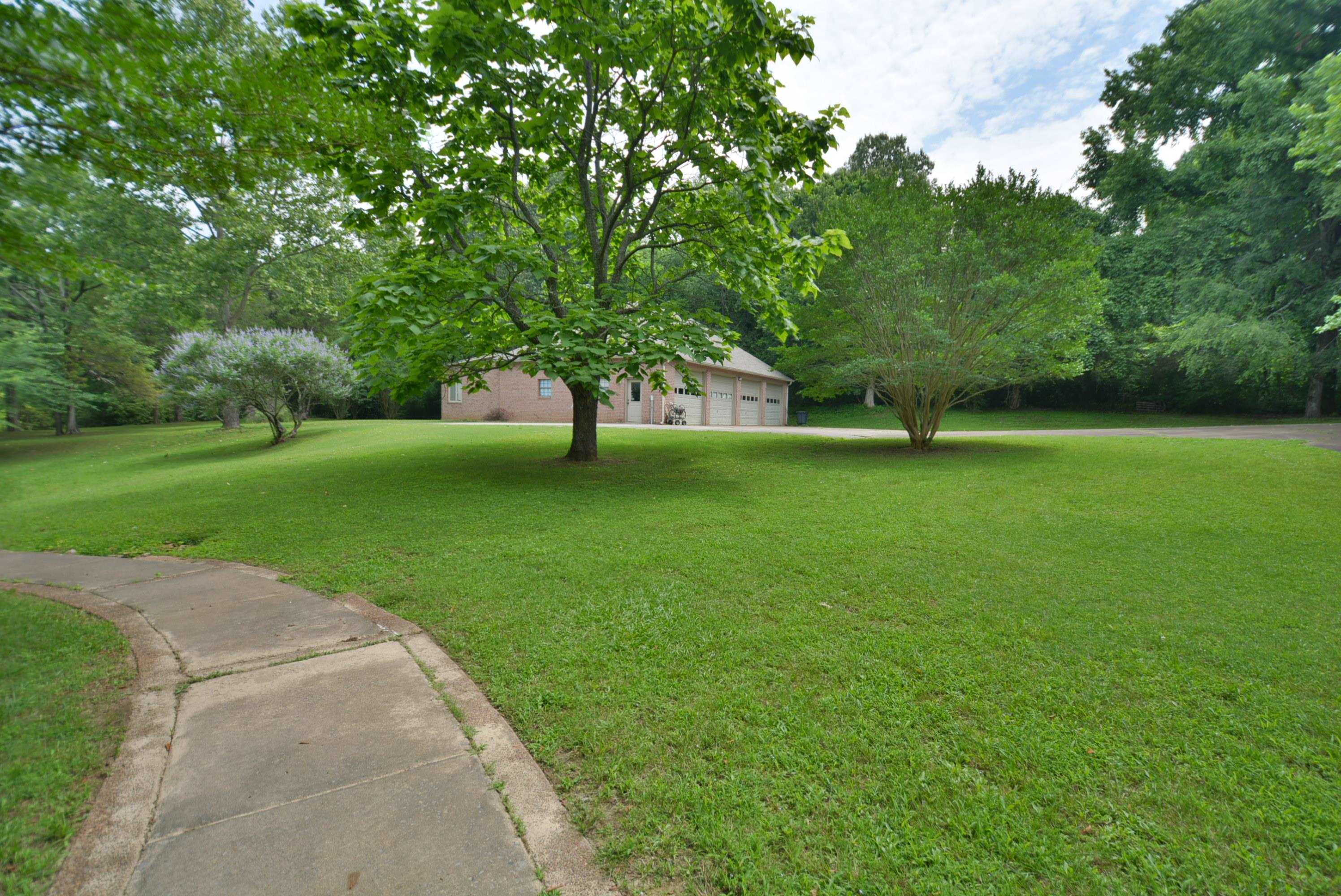 6500 State Line Road Memphis, TN 38141 - Photo 34 of 40 View of green lawn with an attached garage