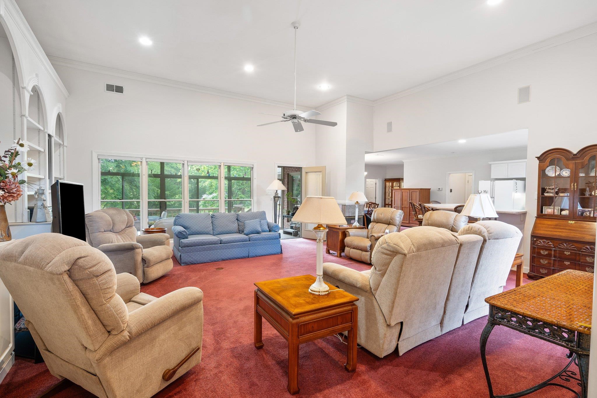 6500 State Line Road Memphis, TN 38141 - Photo 6 of 40 Carpeted living area with a high ceiling, crown molding, recessed lighting, and a ceiling fan