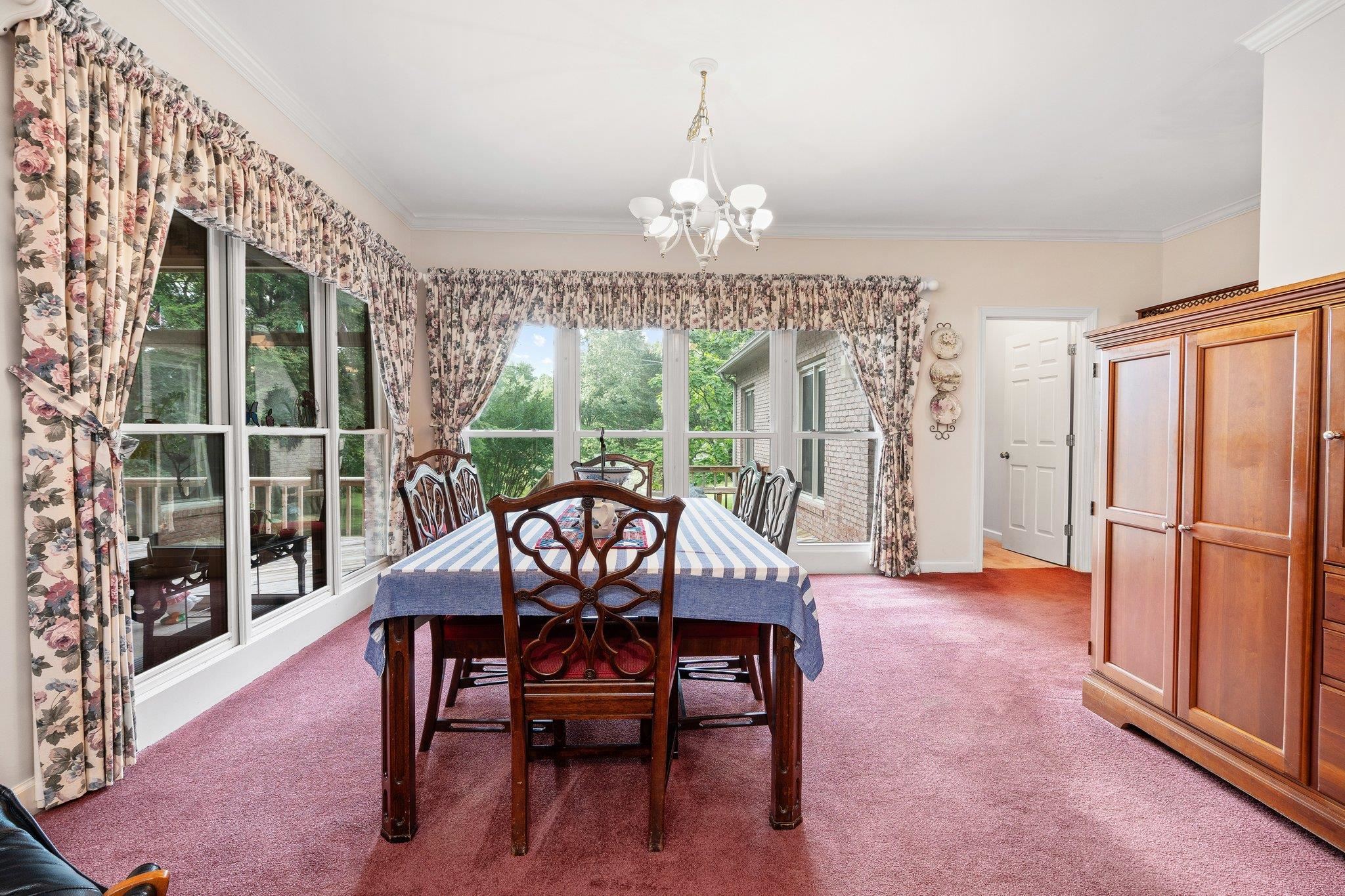 6500 State Line Road Memphis, TN 38141 - Photo 10 of 40 Carpeted dining space with a chandelier and crown molding