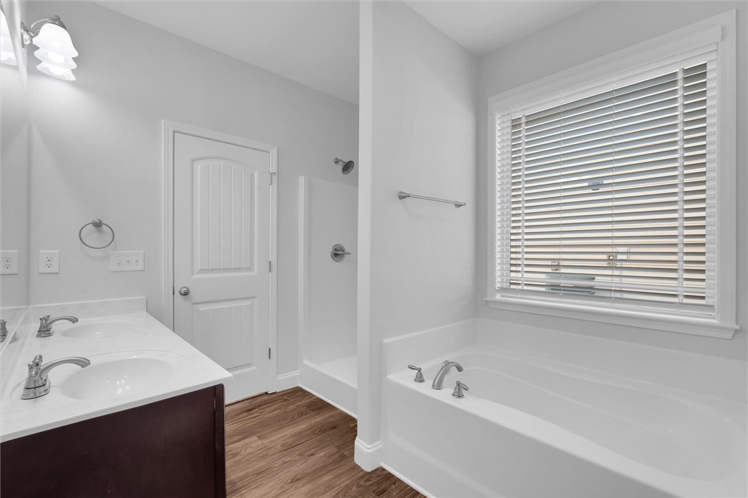 155 Norfolk Circle Anderson, SC 29625 - Photo 14 of 33 This bright bathroom features a double vanity, a deep soaking tub, and a separate walk-in shower.