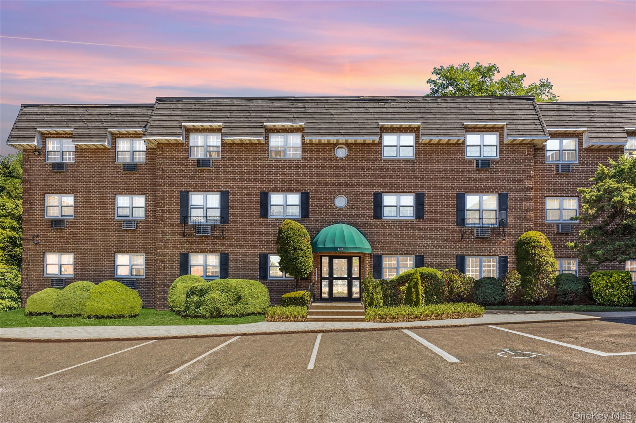 a view of a brick building next to a yard