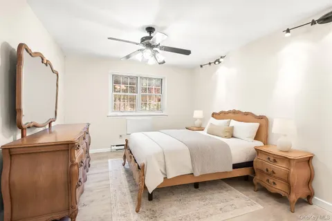 a bedroom with a bed and a mirror