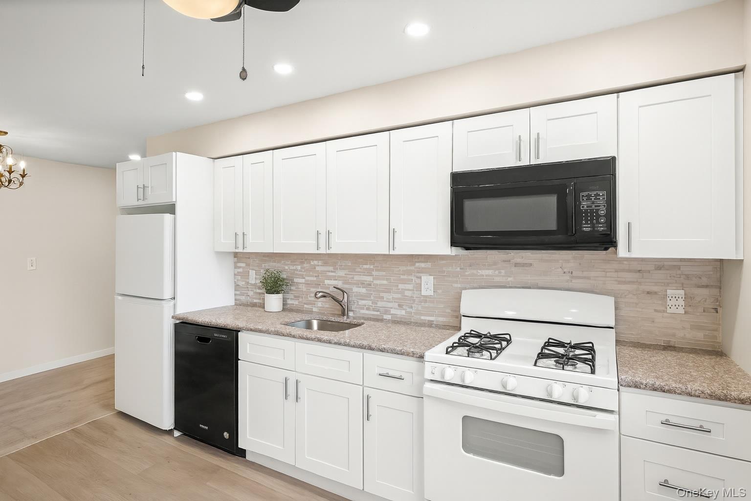 400 Maryland Avenue, Unit 1D Staten Island, NY 10305 - Photo 3 of 19 a kitchen with a sink stove and microwave