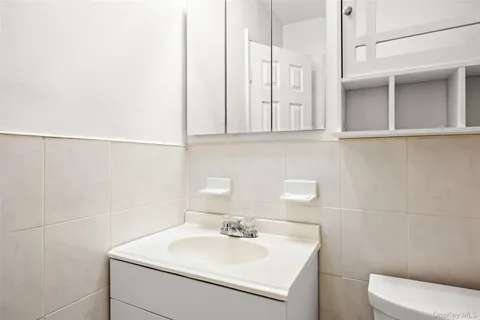 a bathroom with a sink a toilet and mirror