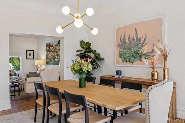 a view of a dining room with furniture and chandelier