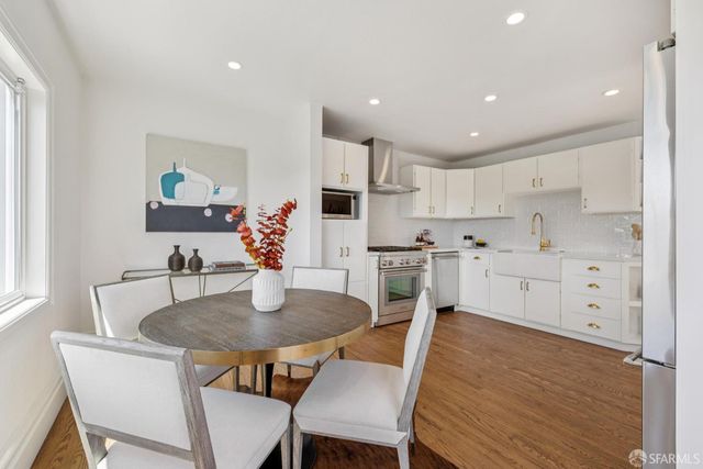 a view of kitchen with cabinets table and chairs