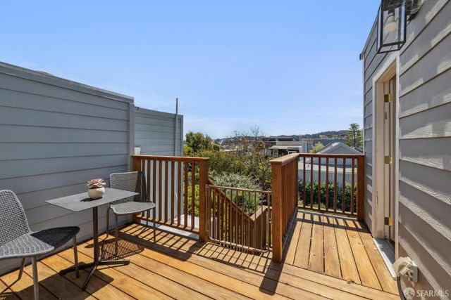a view of a balcony with wooden floor