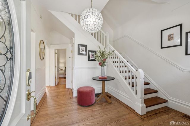 a view of entryway and hall with wooden floor