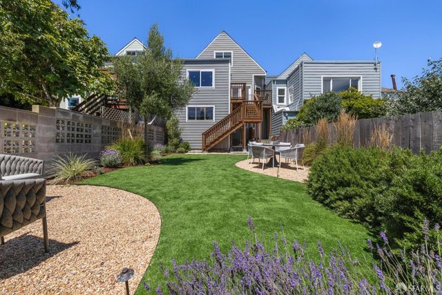 a front view of a house with a garden and plants