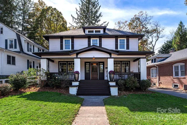 a front view of a house with garden and porch
