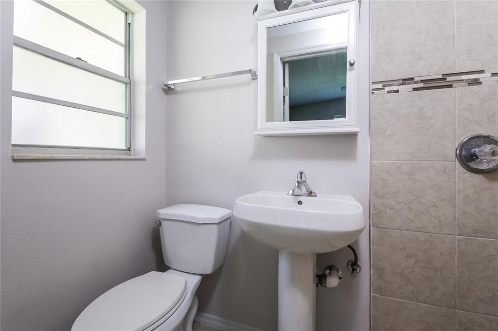 1911 3rd Avenue East Bradenton, FL 34208 - Photo 9 of 15 a bathroom with a toilet sink and mirror