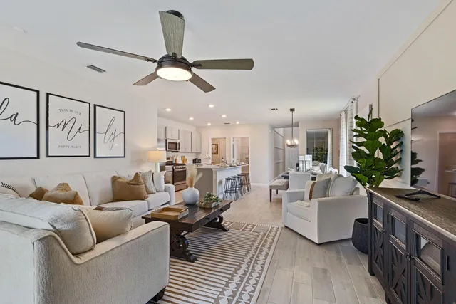 a living room with furniture and a chandelier