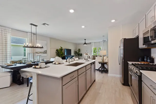 a kitchen with a sink stove and refrigerator