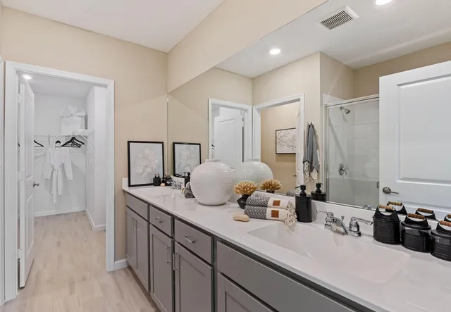 a bathroom with a double vanity sink and mirror