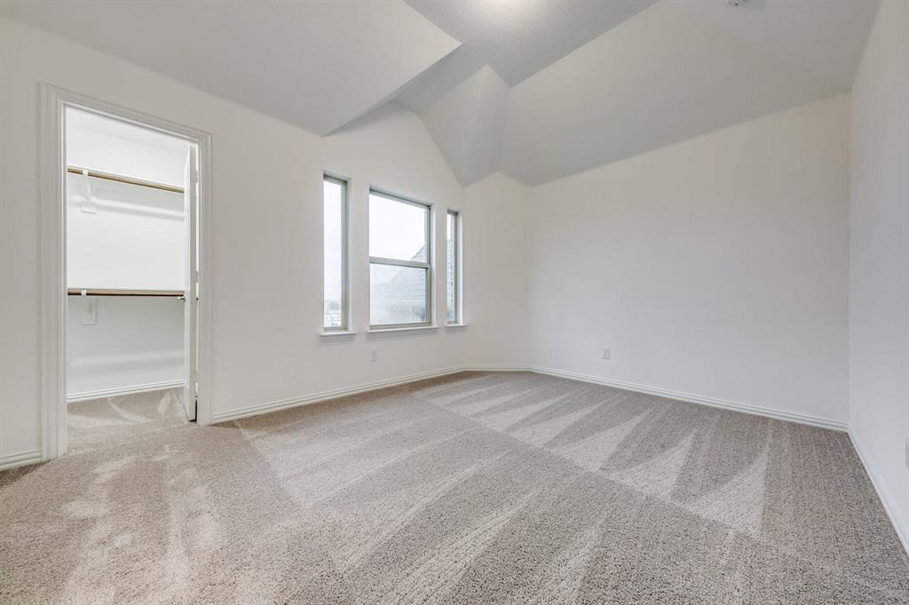 104 Sweetleaf Drive Red Oak, TX 75154 - Photo 22 of 36 Well-lit room featuring neutral-toned carpeting, white walls, and a vaulted ceiling