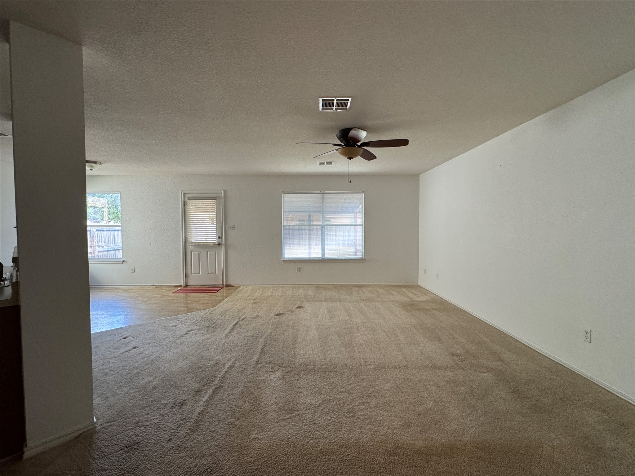 18420 Wind Tree Lane Elgin, TX 78621 - Photo 3 of 15 an empty room with a empty space and windows