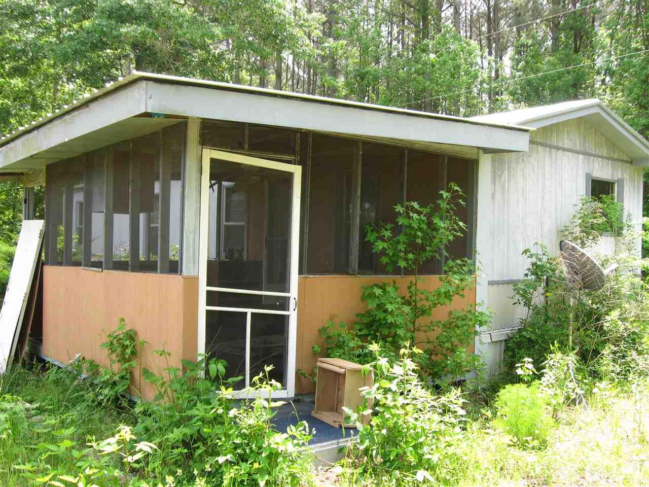 Screen porch added to the front of the house. Be careful of broken glass.