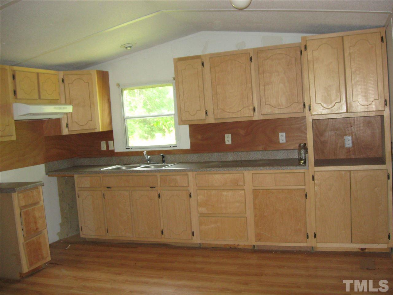 New unfinished cabinets in the kitchen. No appliances.