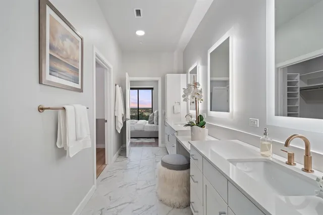 a spacious bathroom with a sink and mirror