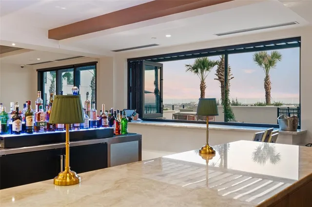 a living room with furniture and a floor to ceiling window