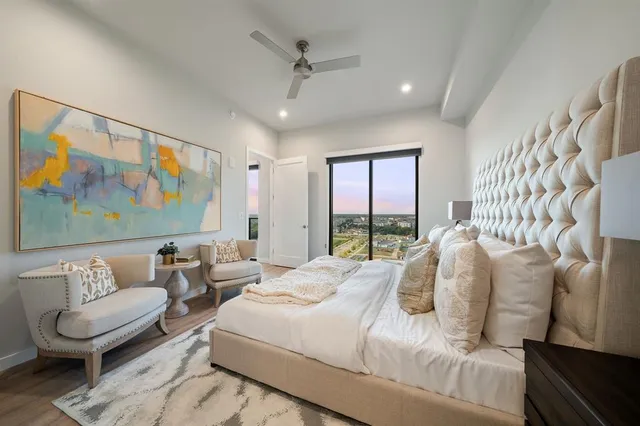 a bedroom with a bed and glass walk in closet