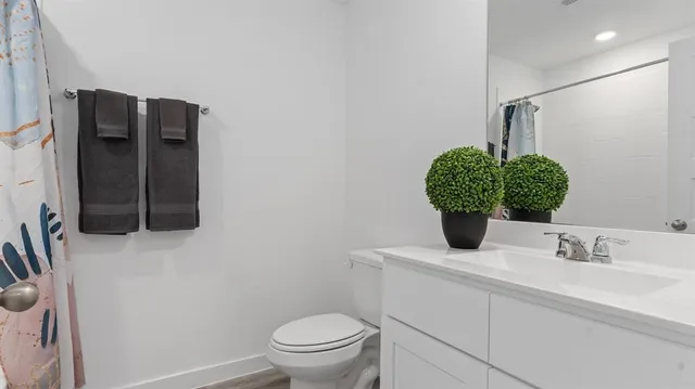 a bathroom with a sink toilet and mirror