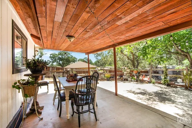 a view of a patio with table and chairs and potted plants
