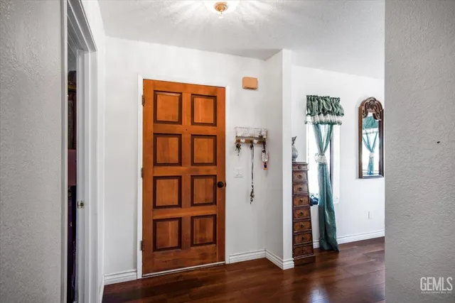 an empty room with wooden floor and closet